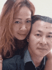 a man and a woman are posing for a photo