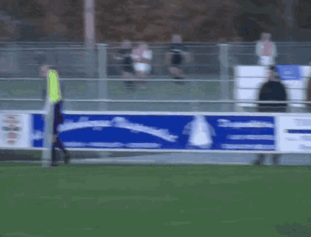a blurred image of a soccer field with a blue banner that says ' e ' on it