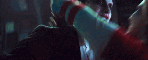 a man and woman are kissing in a dark room .