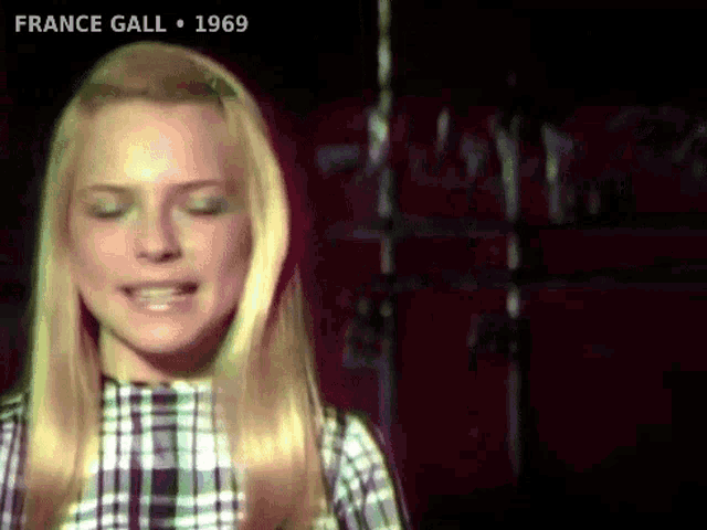 a close up of a woman 's face with the words france gall 1969 on the bottom