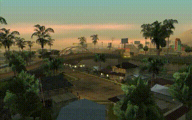 an aerial view of a city with palm trees in the foreground