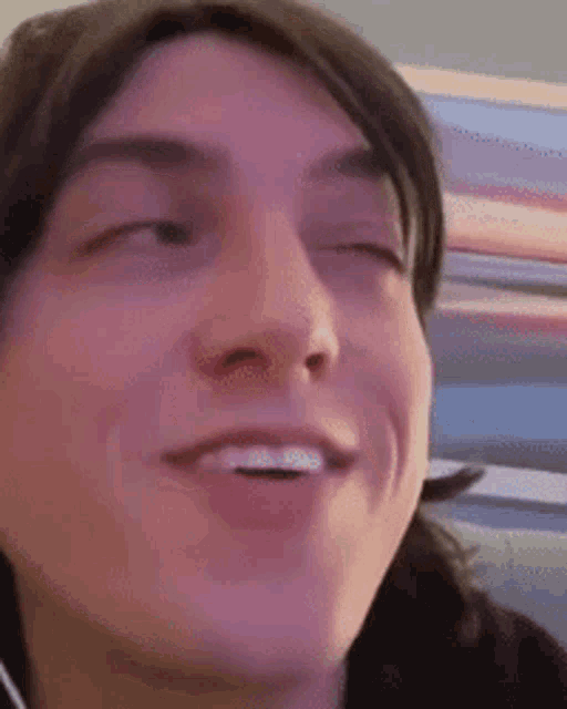 a close up of a man 's face with his mouth open .