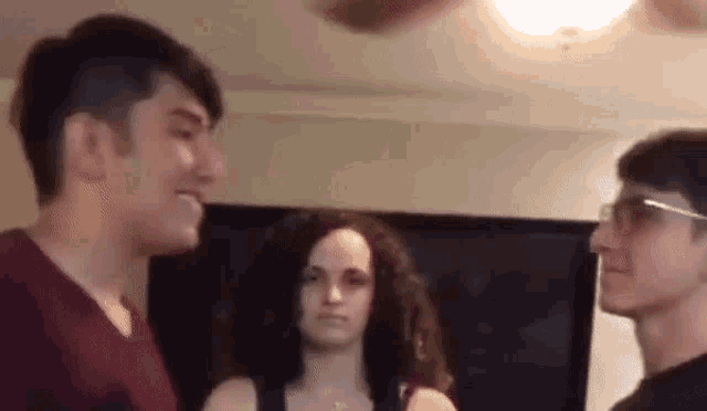 a man and a woman are standing next to each other in a room .