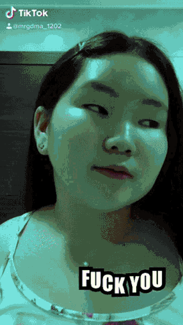 a girl 's face is shown with the words " fuck you " on her face
