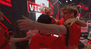 a group of people hugging each other in front of a sign that says victor