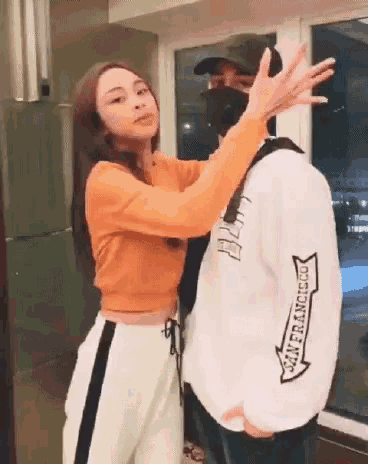 a woman is hugging a man wearing a san francisco shirt