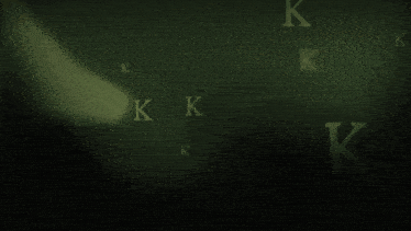 the letters k and n are floating in the air on a green background