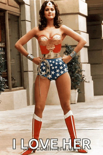 a woman in a wonder woman costume is standing in front of a building