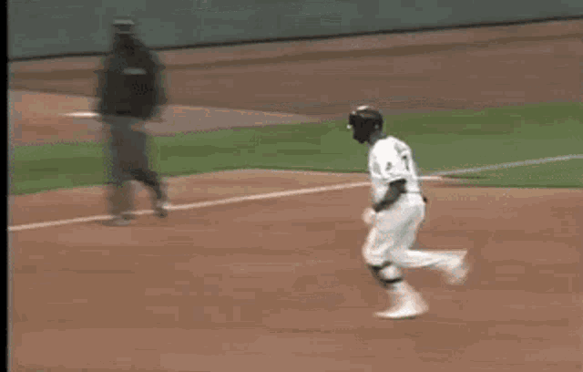 a blurry picture of a baseball game with a coca cola ad in the background