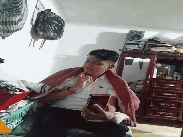a person laying on a bed with a backpack that says jc