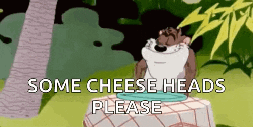 a cartoon character sitting at a table with the words some cheese heads please