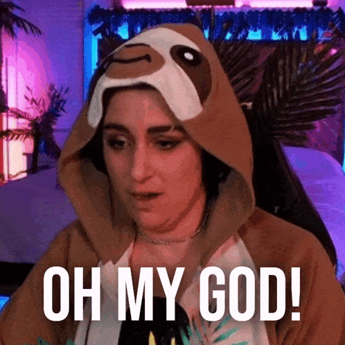 a woman wearing a sloth costume is sitting in front of a computer .