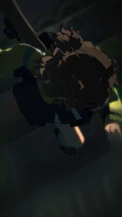 a green laser beam is shining on a black background