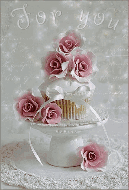 a picture of a cupcake with pink roses and the words " for you " in the background