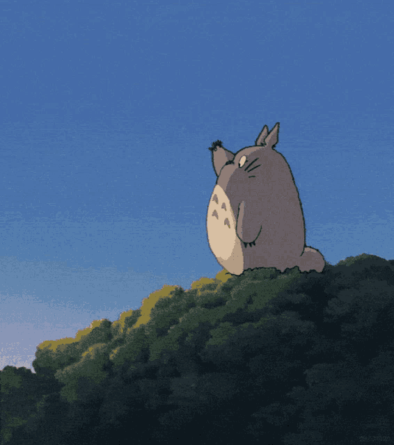 a cartoon of a totoro sitting on top of a tree