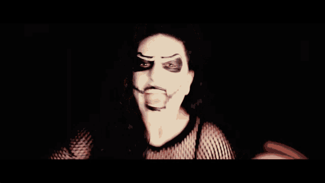 a woman with a white face painted like a skull