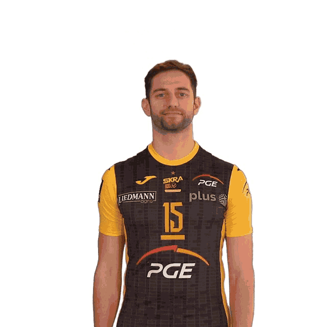 a man wearing a black and yellow shirt with the number 15 on it flexes his muscles
