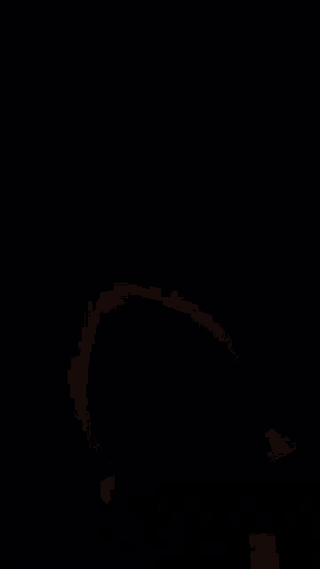 a person 's hand is holding a glowing object in their hand
