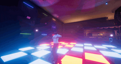a man stands on a dance floor in a dark room with purple and blue lights