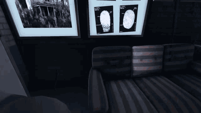 a man 's hand is reaching out towards a wall with a picture on it that says ' a ' on it