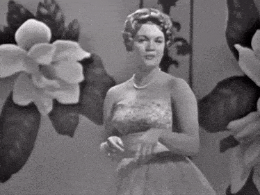 a woman in a strapless dress with a pearl necklace
