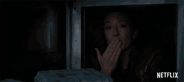 a woman looking out of a window with netflix written on the bottom