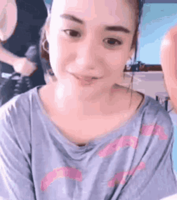 a close up of a woman wearing a blue shirt