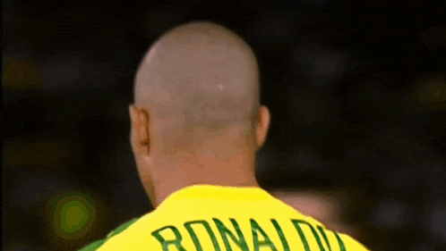 a man with a yellow shirt that says ronaldo