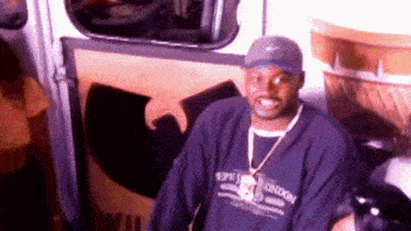 a man wearing a hat and a sweater that says london