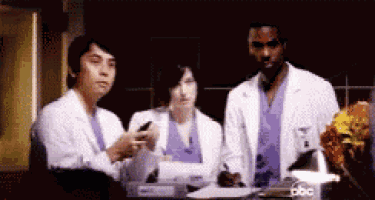 a group of doctors are standing around a table with abc written on the bottom