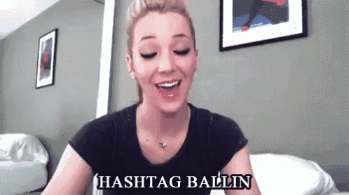 a woman in a black shirt is smiling with the words hashtag ballin written below her