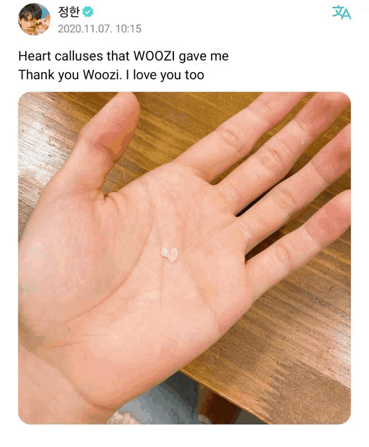 a person holding a small object in their hand with a message that says heart calluses that woozi gave me thank you woozi