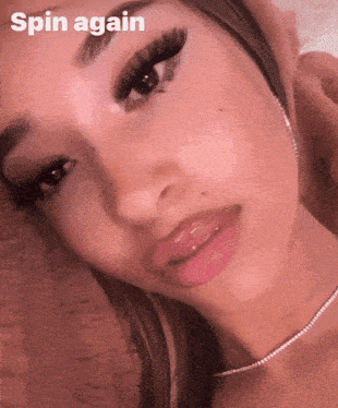 a close up of a woman 's face with the words spin again below it