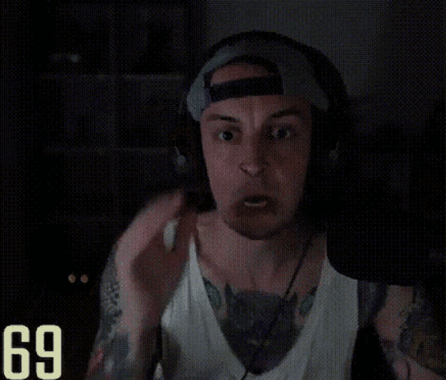 a man wearing headphones and a hat has the number 69 on the bottom right