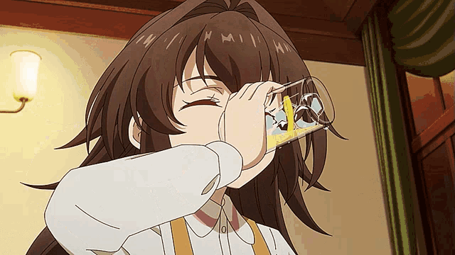 a girl in a white shirt is drinking from a glass with a cartoon character on it