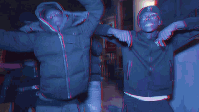 a man wearing a jacket that says night is dancing with his hands in the air