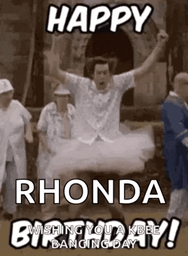 a man in a tutu is jumping in the air while a group of people are standing around him .