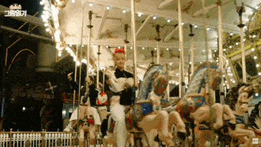 a merry go round in an amusement park with a sign that says ' the very first ' on it