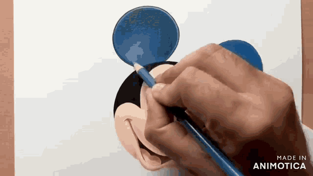 a person is drawing mickey mouse 's head with a blue pencil .