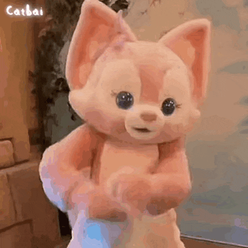 a stuffed animal is being held in someone 's arms .
