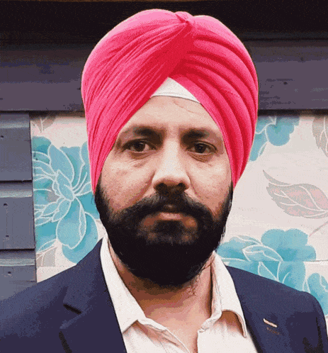 a man with a beard and a pink turban