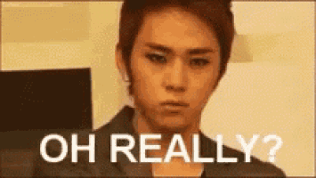 a young man is making a funny face with the words `` oh really '' written above him .