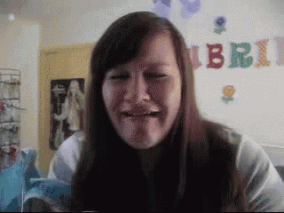 a woman is making a funny face in front of a sign that says bubble