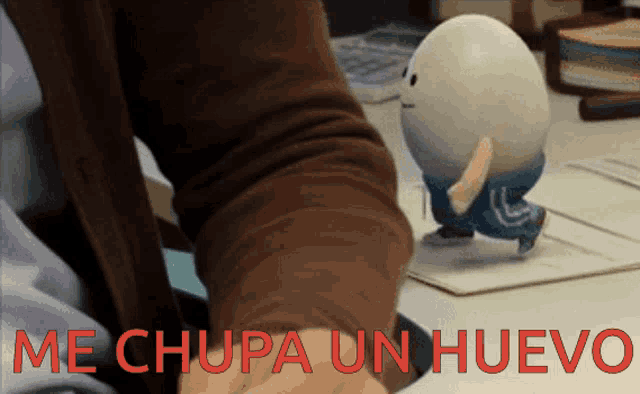 a person is holding a toy egg that says me chupa un huevo on it