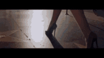 a woman wearing high heels is walking on a star walkway .
