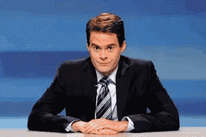 a man in a suit and tie is sitting at a table
