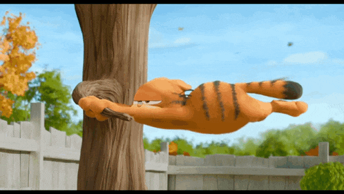 garfield is hanging upside down on a tree