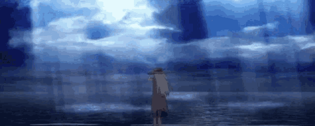a person is standing in the water looking at the sky