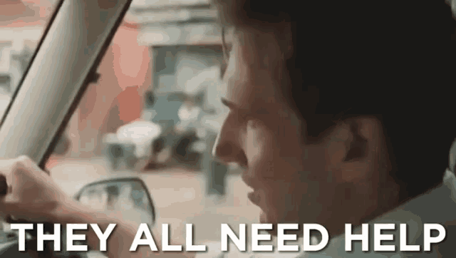 a man driving a car with the words they all need help written on the screen