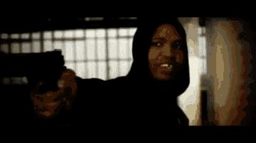 a blurred image of a person holding a gun